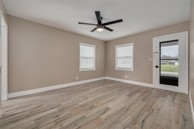 unfurnished room featuring ceiling fan and light hardwood / wood-style floors