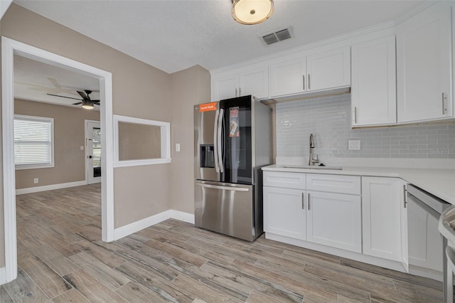 kitchen featuring stainless steel fridge with ice dispenser, white cabinets, and light wood-type flooring