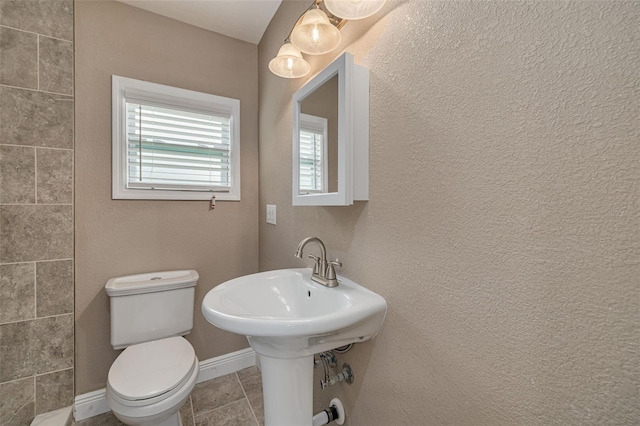 bathroom with plenty of natural light and toilet