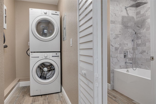 washroom featuring stacked washing maching and dryer