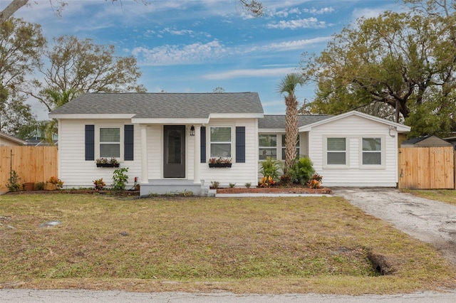 single story home featuring a front lawn