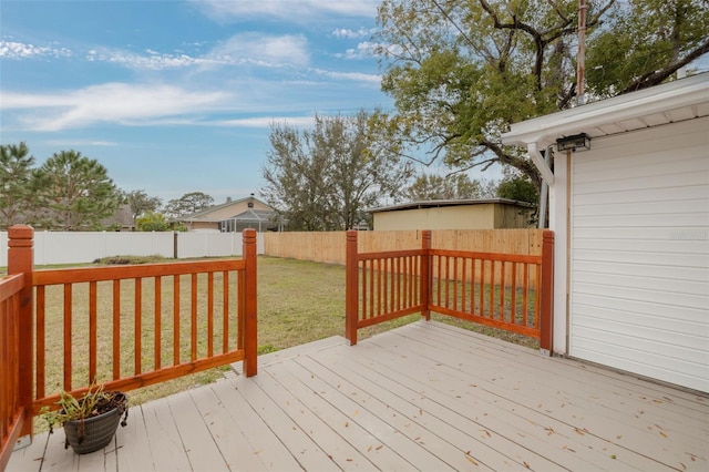 wooden deck featuring a yard