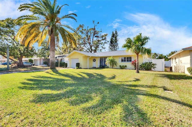 ranch-style house with a garage and a front yard