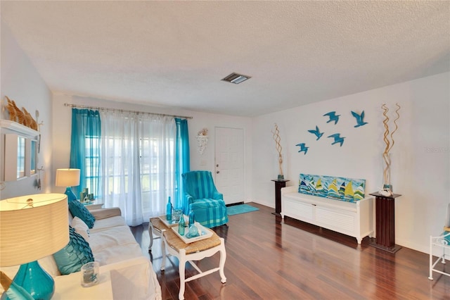 2589 Redwood Cir, Clearwater, FL 33763 - living room with wood finished floors, a textured ceiling, and baseboards