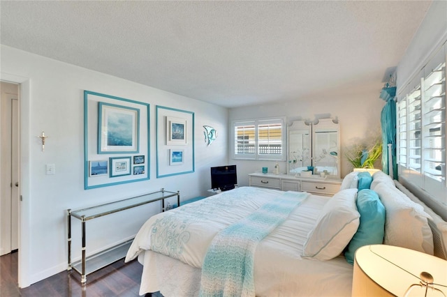 2589 Redwood Cir, Clearwater, FL 33763 - bedroom featuring dark wood-type flooring, a textured ceiling, and baseboards