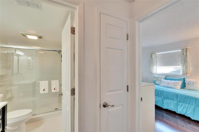 2589 Redwood Cir, Clearwater, FL 33763 - bathroom featuring a stall shower, toilet, ensuite bathroom, and vanity