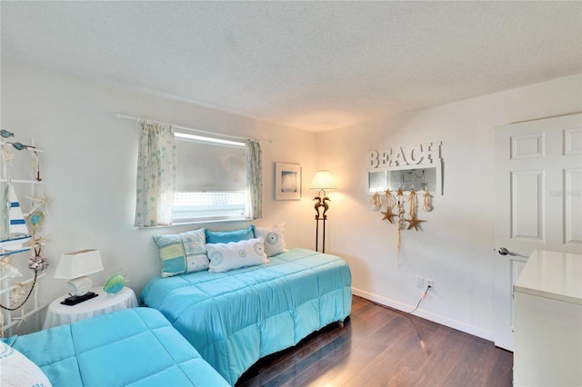 2589 Redwood Cir, Clearwater, FL 33763 - bedroom featuring dark wood-type flooring, a textured ceiling, and baseboards