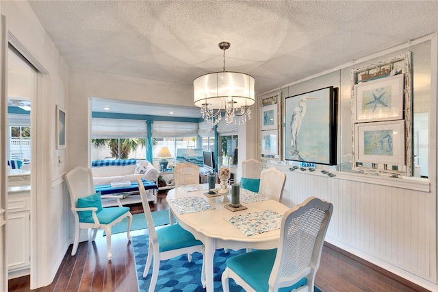 2589 Redwood Cir, Clearwater, FL 33763 - dining space with dark wood-style flooring, a chandelier, and a textured ceiling