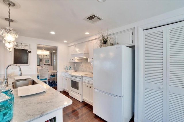 2589 Redwood Cir, Clearwater, FL 33763 - kitchen with white appliances, a sink, custom range hood, a chandelier, and white cabinets