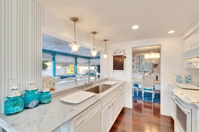 2589 Redwood Cir, Clearwater, FL 33763 - kitchen featuring a sink, white appliances, dark wood-style flooring, decorative light fixtures, and white cabinetry