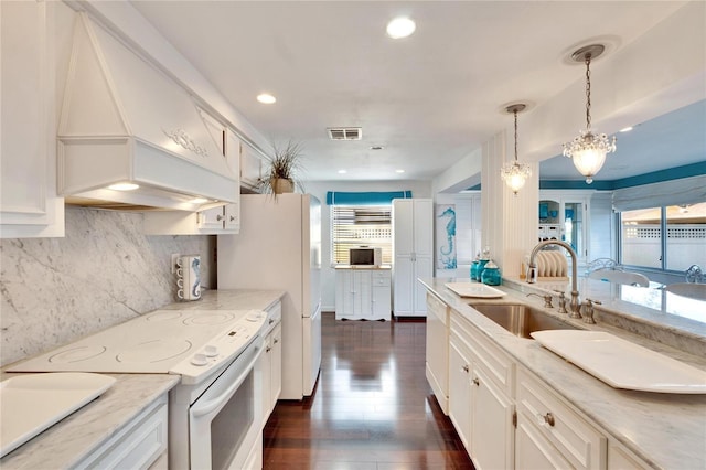 2589 Redwood Cir, Clearwater, FL 33763 - kitchen with white appliances, a sink, custom range hood, white cabinets, and recessed lighting