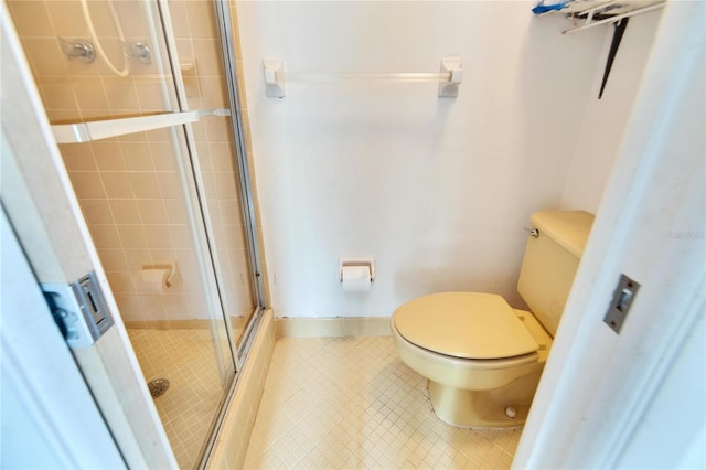 2589 Redwood Cir, Clearwater, FL 33763 - bathroom featuring toilet, a shower stall, and tile patterned floors