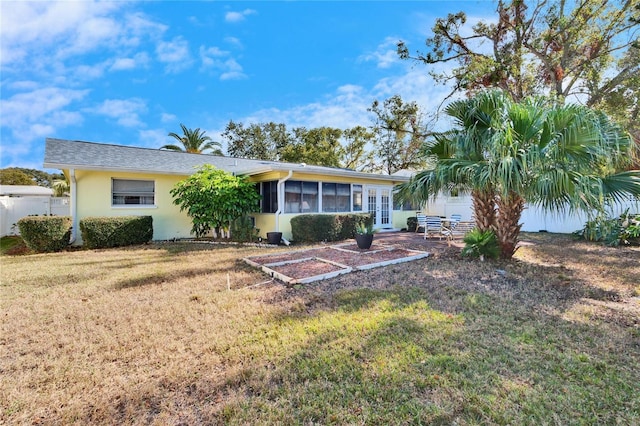 2589 Redwood Cir, Clearwater, FL 33763 - back of house featuring french doors, stucco siding, and a sunroom