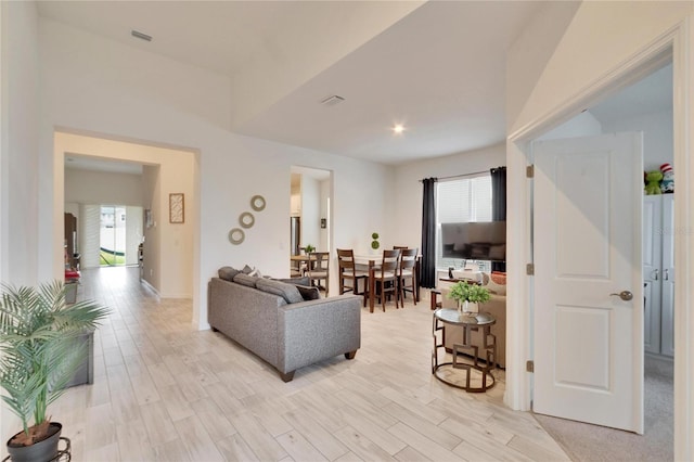 living room with a wealth of natural light and light hardwood / wood-style floors