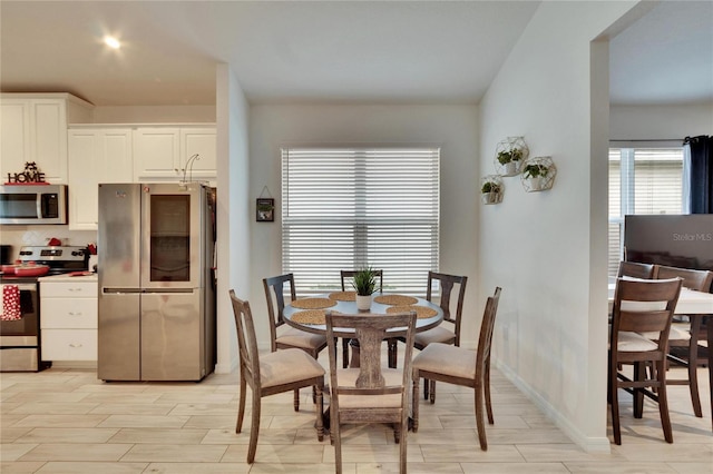 dining space with light wood-type flooring