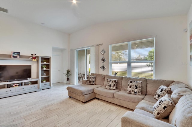 living room with lofted ceiling and light hardwood / wood-style flooring