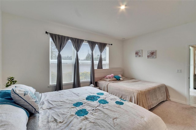 bedroom featuring light carpet