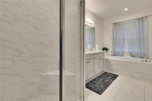 bathroom featuring vanity and shower with separate bathtub