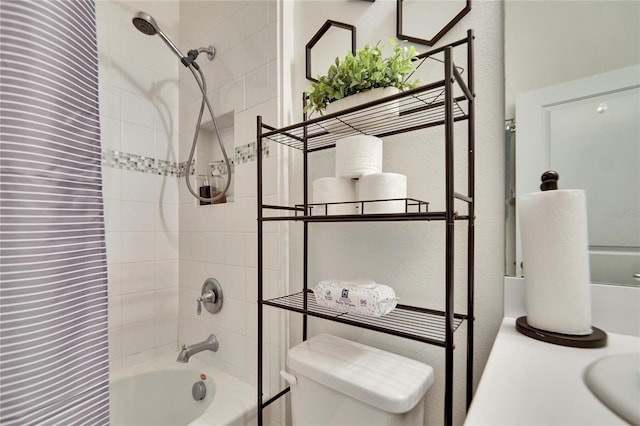 bathroom featuring tiled shower / bath combo and toilet