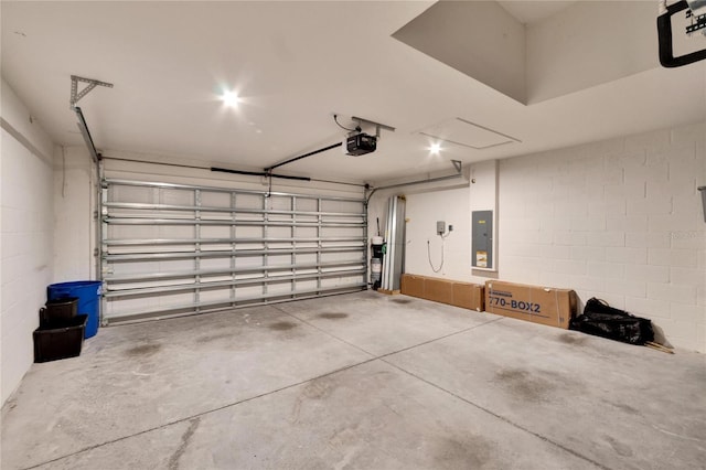 garage with a garage door opener and electric panel