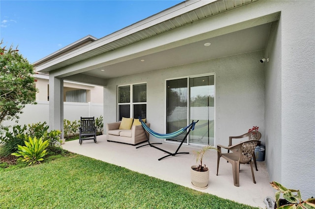 back of house featuring a patio area and a lawn