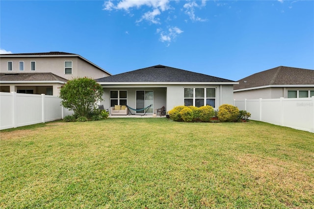 rear view of house with a yard