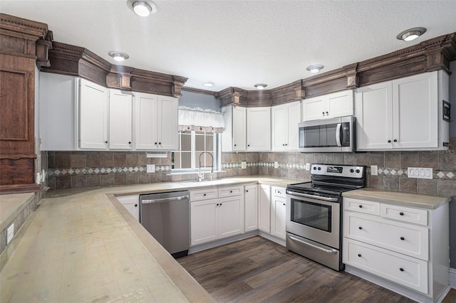 kitchen with white cabinetry, sink, dark hardwood / wood-style flooring, and stainless steel appliances