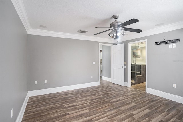 empty room with crown molding, dark wood-type flooring, ceiling fan, and a textured ceiling