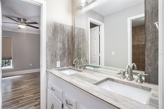 bathroom with hardwood / wood-style flooring, ceiling fan, vanity, and crown molding