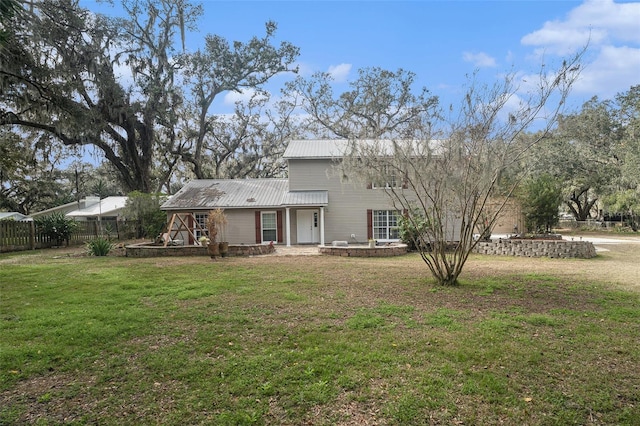 back of property featuring a lawn