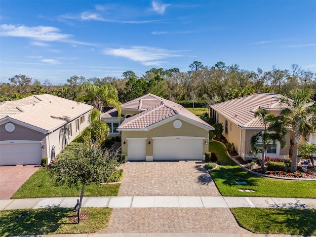 view of front of home with a garage and a front yard