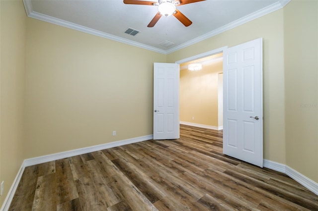 unfurnished bedroom featuring crown molding, ceiling fan, and dark wood-type flooring