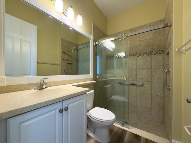 bathroom with vanity, hardwood / wood-style floors, toilet, and walk in shower