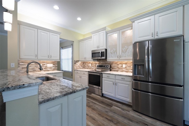 kitchen featuring white cabinetry, ornamental molding, appliances with stainless steel finishes, and sink