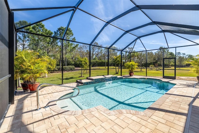 view of pool with pool water feature, a lanai, a patio area, and a lawn