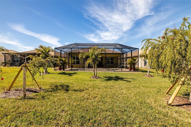 back of house featuring a lanai and a lawn