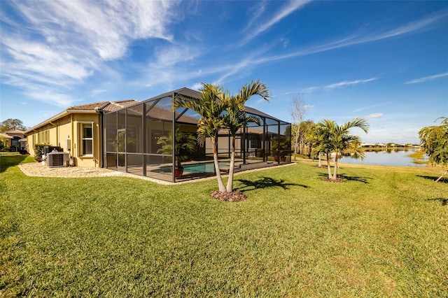 view of yard featuring a water view, glass enclosure, and central air condition unit