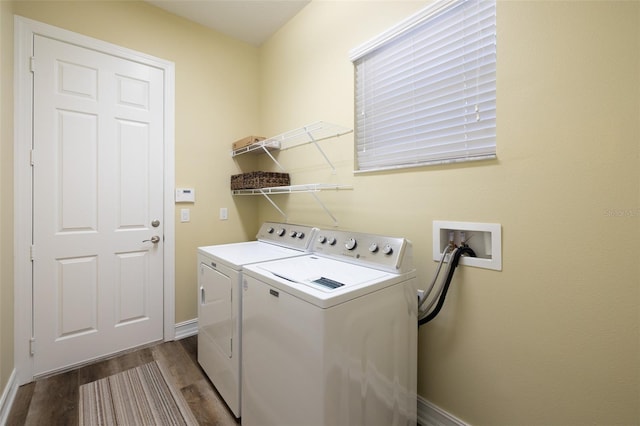 washroom with washing machine and dryer and light hardwood / wood-style floors