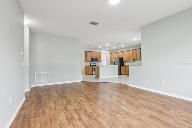 unfurnished living room with light hardwood / wood-style flooring