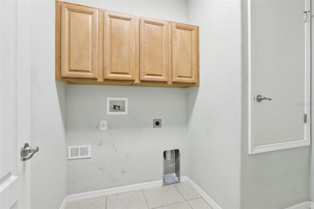 washroom featuring cabinets, electric dryer hookup, hookup for a washing machine, and light tile patterned floors