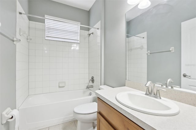 full bathroom featuring tiled shower / bath combo, vanity, tile patterned floors, and toilet