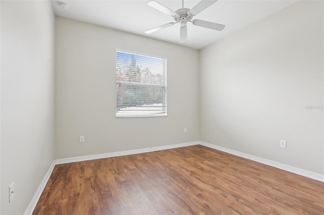 empty room featuring hardwood / wood-style flooring and ceiling fan