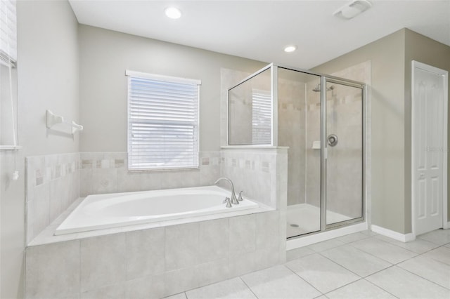 bathroom with tile patterned floors and separate shower and tub