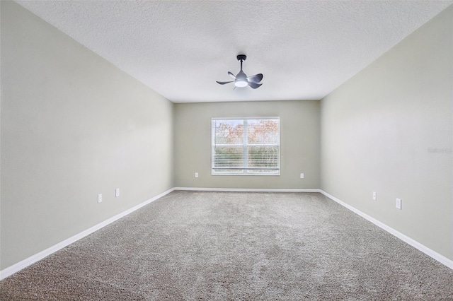 carpeted empty room with ceiling fan and a textured ceiling