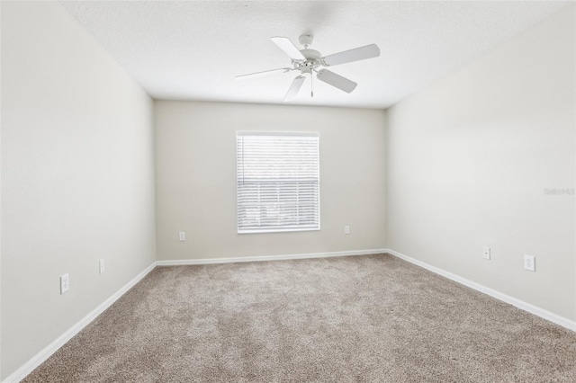 spare room with ceiling fan, carpet floors, and a textured ceiling