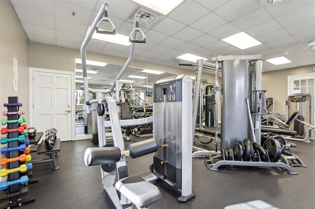 gym with a paneled ceiling