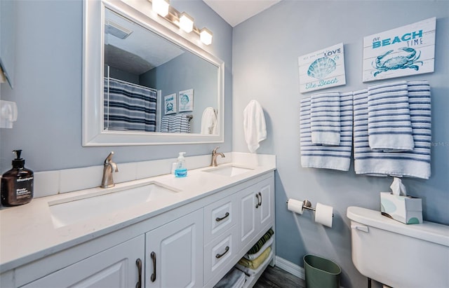 bathroom featuring vanity, toilet, and walk in shower