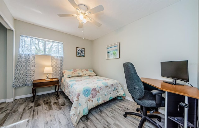 bedroom featuring hardwood / wood-style flooring and ceiling fan