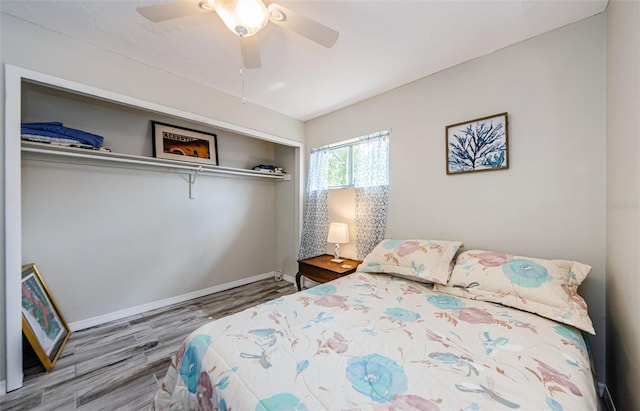 bedroom with wood-type flooring, a closet, and ceiling fan