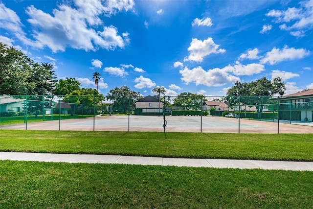 view of sport court featuring a lawn